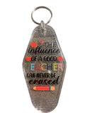 Clear keychain with motivational quote on a gray surface