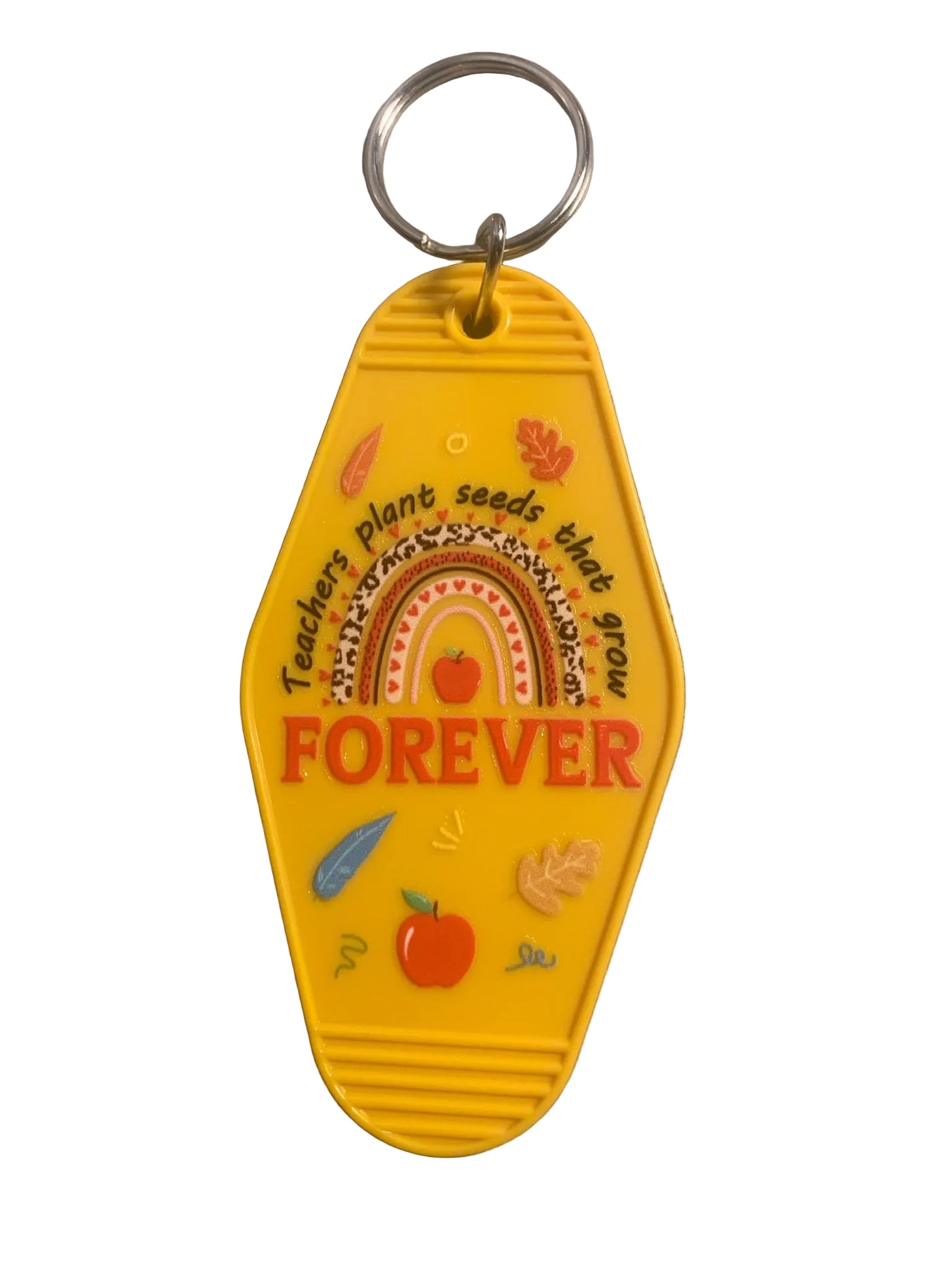 Yellow keychain with 'FOREVER' text and decorative elements on a gray surface